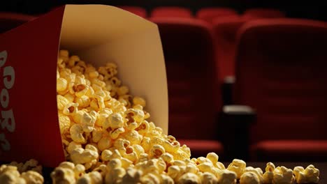 overflowing popcorn in an empty movie theater: capturing the delight and anticipation of cinematic experiences with a focus on snacks and comfort