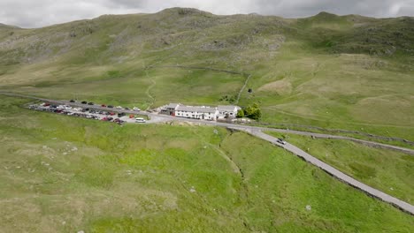 the kirkstone pass inn with cloud shadows and pools of sunlight moving over the rugged landscape. summer. lake district, cumbria, uk