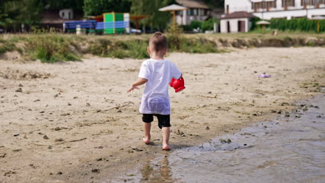 toddler playing on the beach