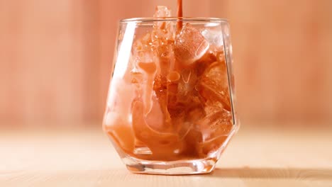 thai tea being poured into a glass