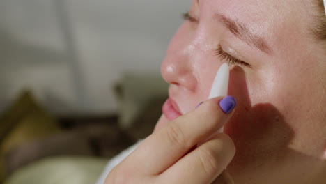 young woman massaging her face