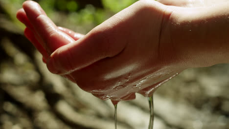 water flowing from hands in nature