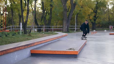 Hipster-skateboarder-riding-and-jumping-in-a-skatepark.-Slow-Motion-shot