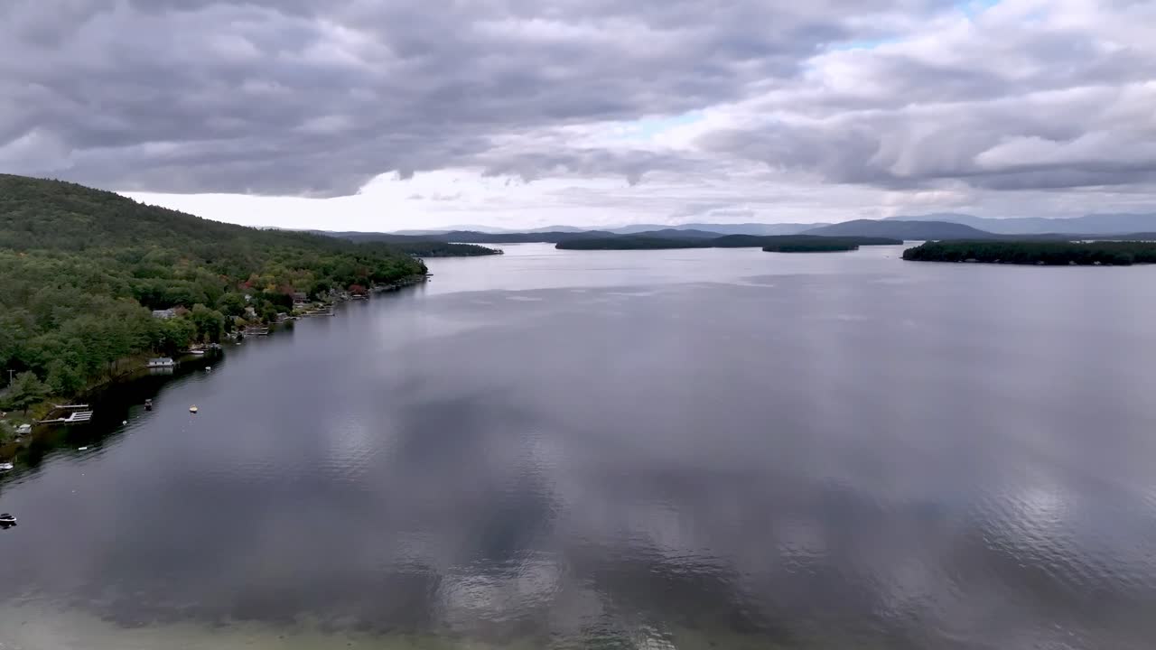 Aerial View of a Serene Lake Surrounded by Colorful Autumn Foliage