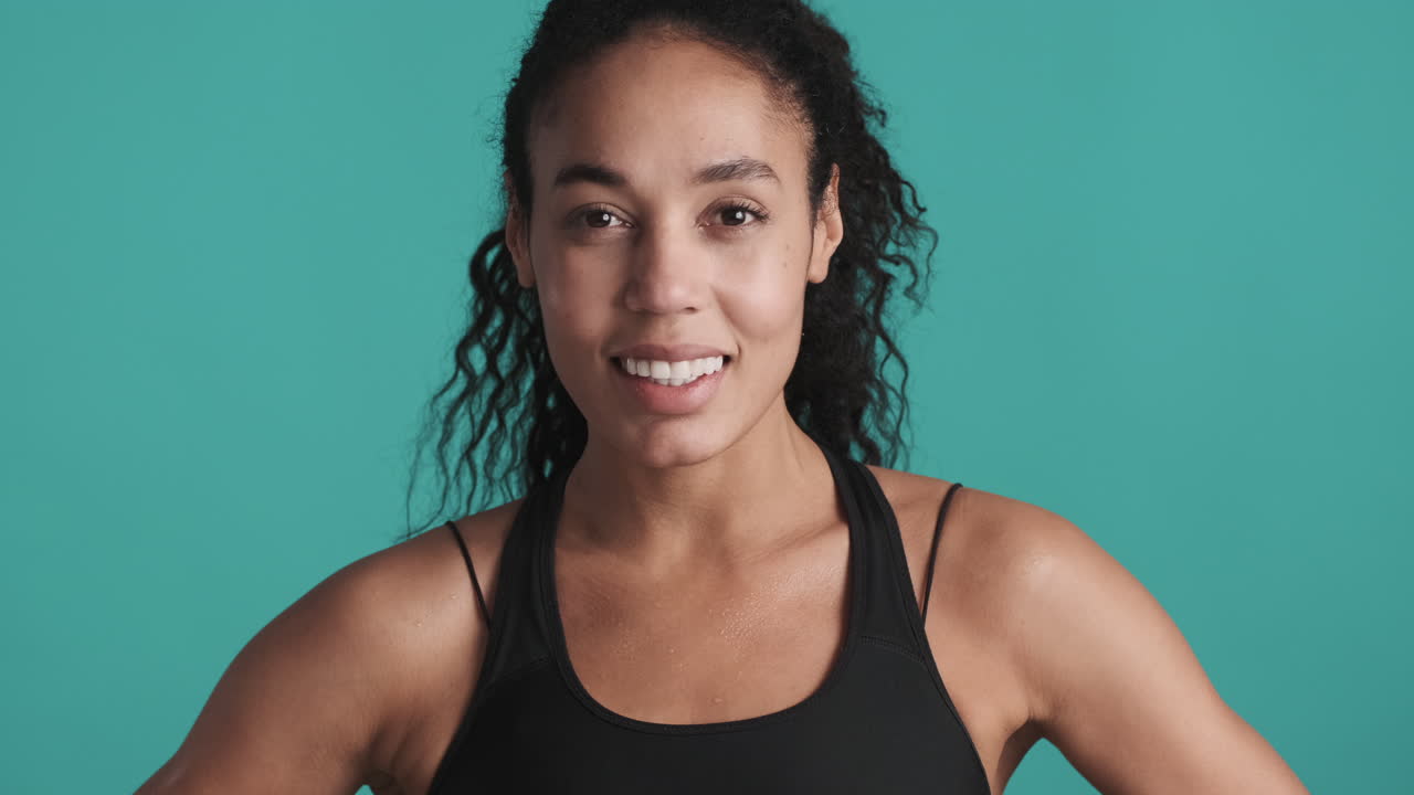 African american happy woman over blue background.
