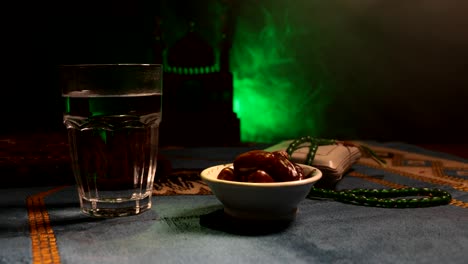 water and dates. iftar is the evening meal. slider view of decoration ramadan kareem holiday. festive greeting card, invitation for muslim holy month ramadan kareem. dark background. selective focus