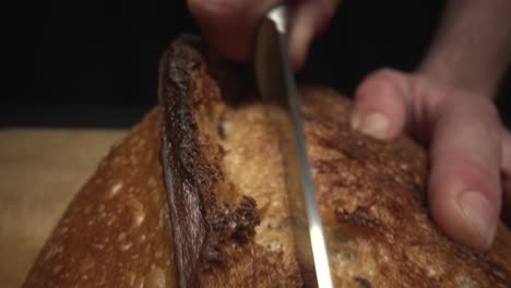 Slow-motion-macro-shot-of-chef-cutting-freshly-baked