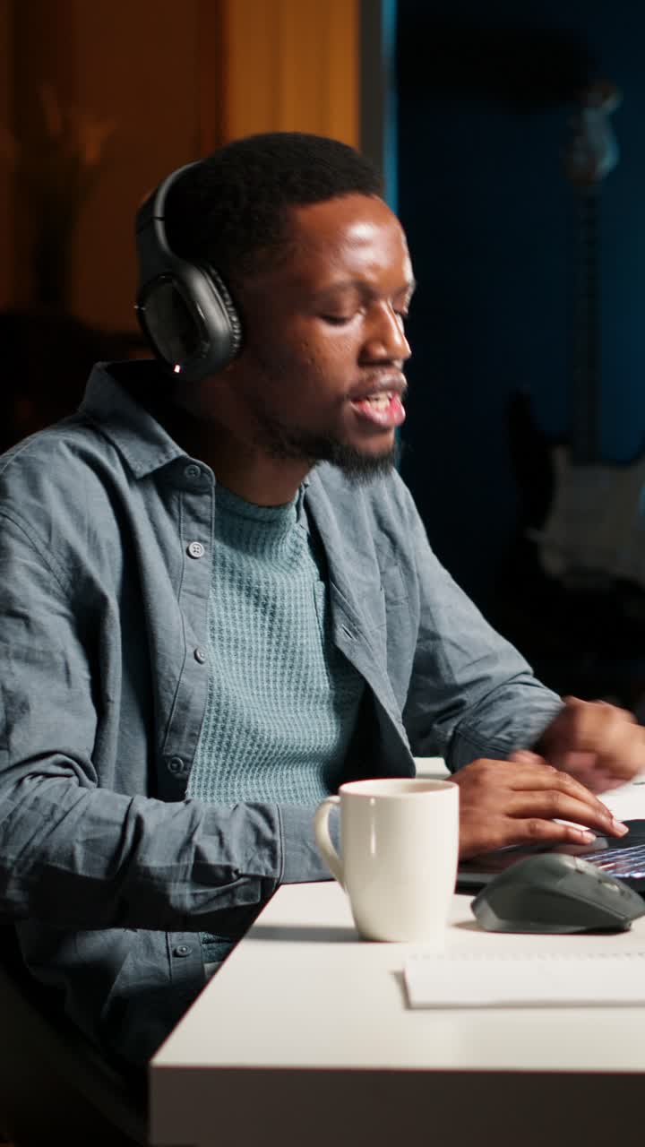 Man working on laptop with headphones