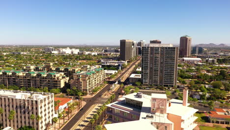 drone flying over high-rise buildings in phoenix on a sunny summer day in arizona, usa