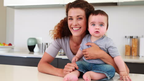 Happy-mother-sitting-with-her-baby-boy