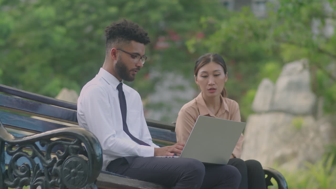 Colleagues Working on Laptop in Park