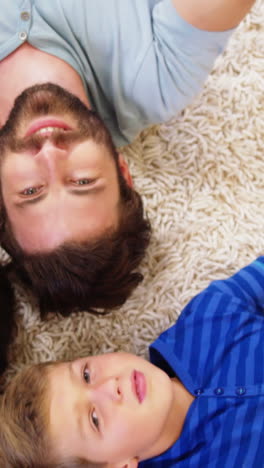 happy family lying on carpet and pointing the camera