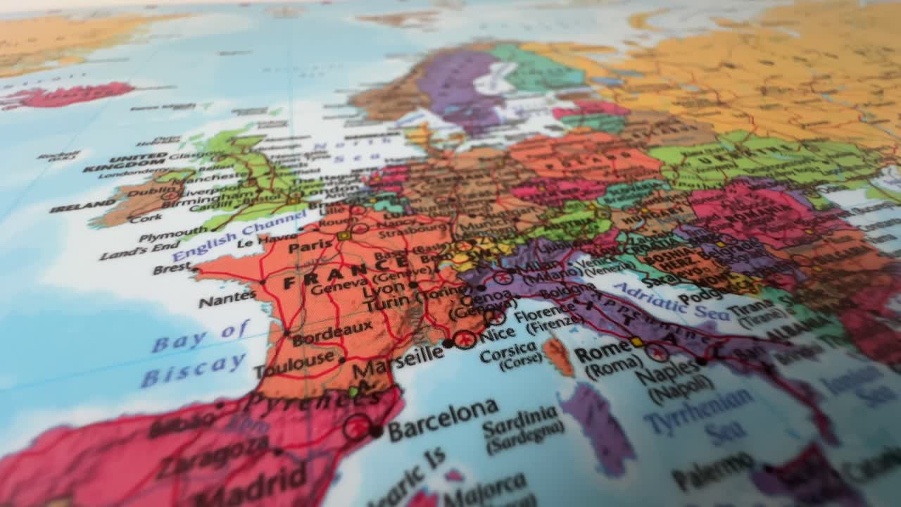 Close-Up of World Map Poster Showing Europe with France, Germany, and Italy Highlighted on Wall