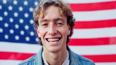 man smiling in front of american flag