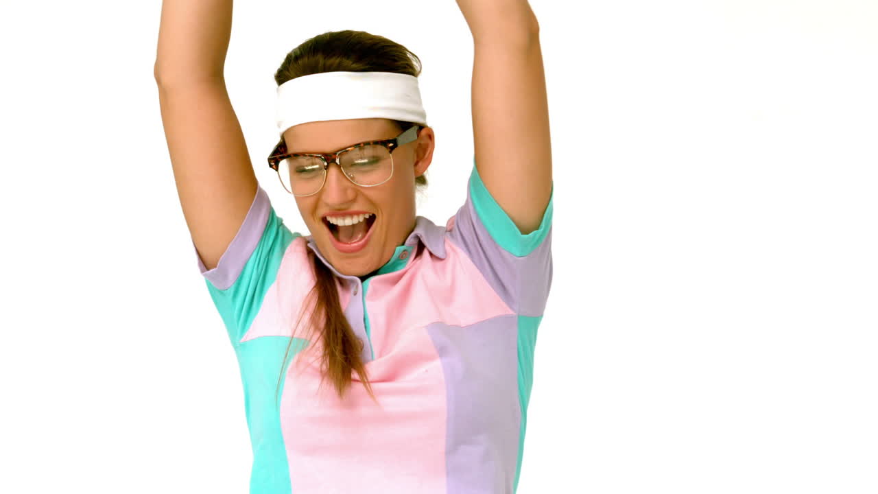 In slow motion geeky hipster holding winners trophy 