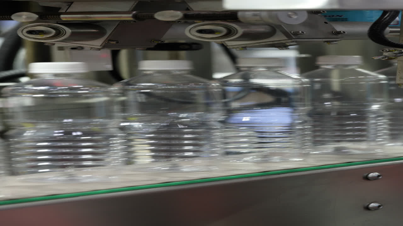 Empty Plastic Bottles Moving on a Conveyor Belt in a Factory