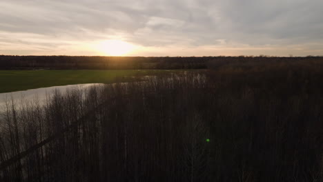 Aerial-shot-of-Loosahatchie-Park-at-sunset-with-serene-water-and-lush-trees,-tranquil-scenery