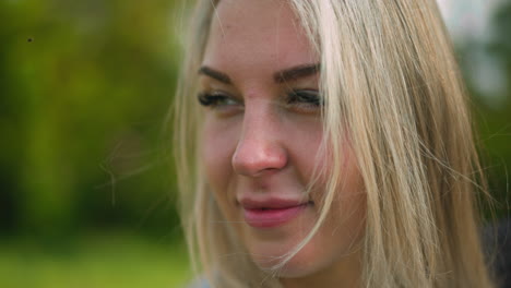 attractive woman smiles for camera standing at light wind