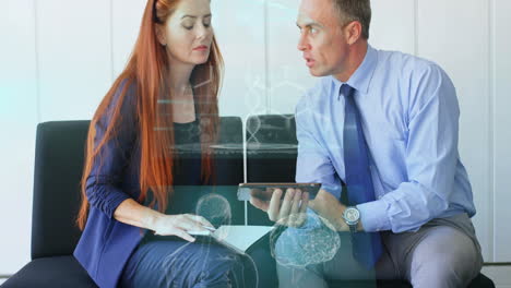 Business team leaning on bench reviewing notebook and tablet, showing animated data charts