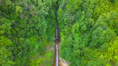 aerial dolly out revealing double waterfall of ribera quente in the jungle of sao miguel island, azores