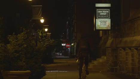 Baltimore-Avenue-sidewalk,-night,-outside-Cavalry-Church-and-curio-theater