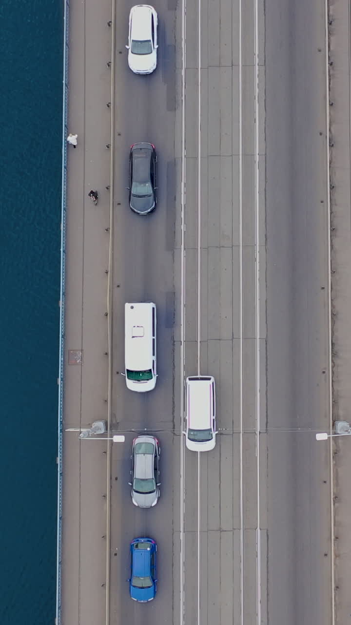 Traffic jam. Car traffic with pedestrians on the bridge over the river. View from the top. Aerial view