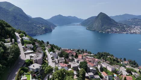 hillside houses overlooking lake lugano switzerland panning drone aerial