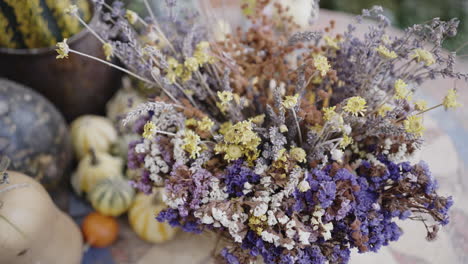 dried flower arrangement with pumpkins