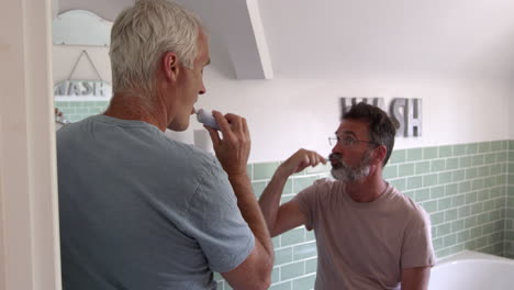 Male-Homosexual-Couple-Brushing-Teeth-In-Bathroom-Together
