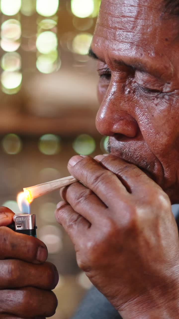 Close-up Portrait of a Man Smoking Incense