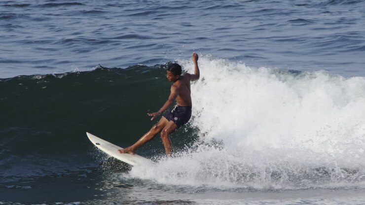 Surfer riding a wave in the ocean