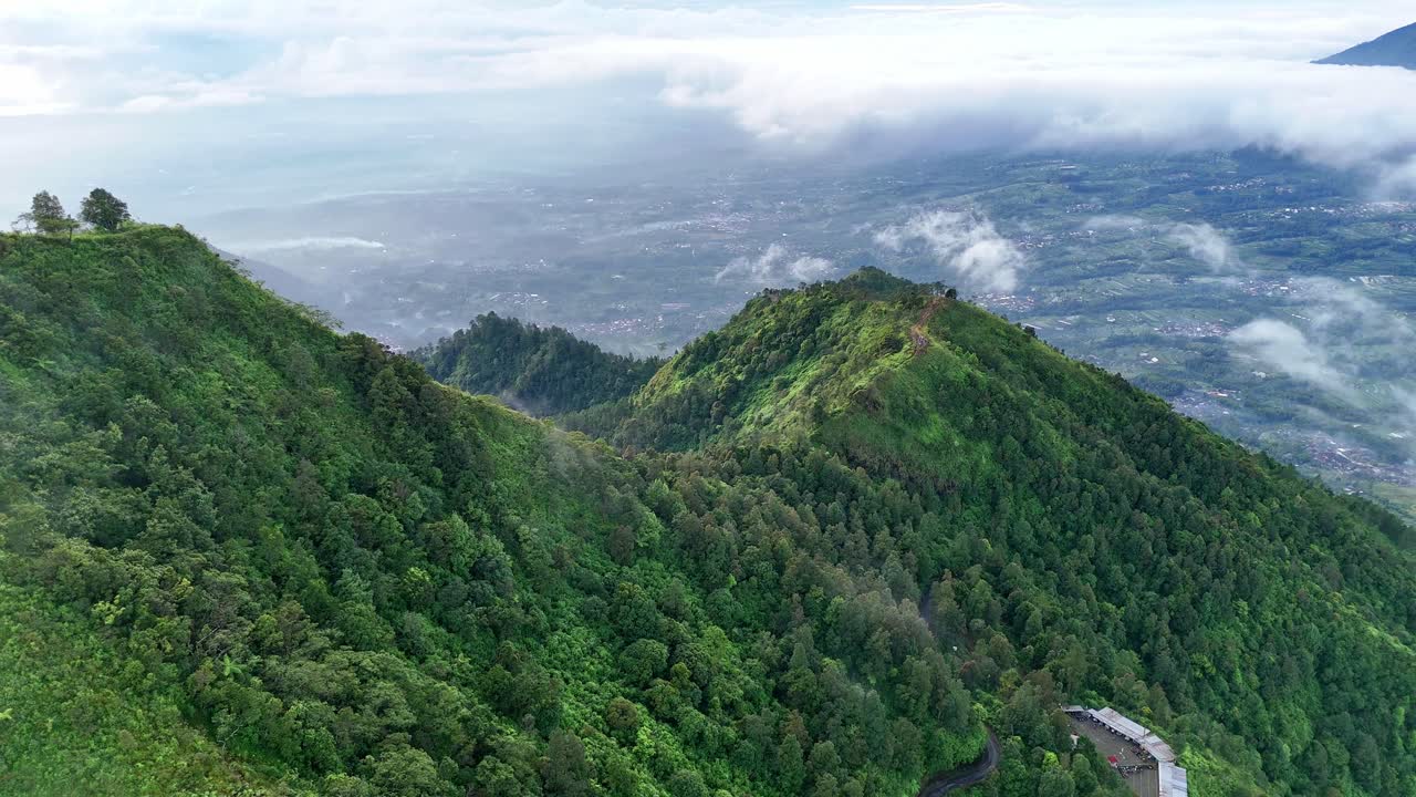 Aerial view of greenery landscape on the hillside. Tropical mountain forest in the morning.