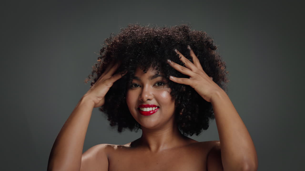 Beautiful African American woman with afro hair and red lipstick