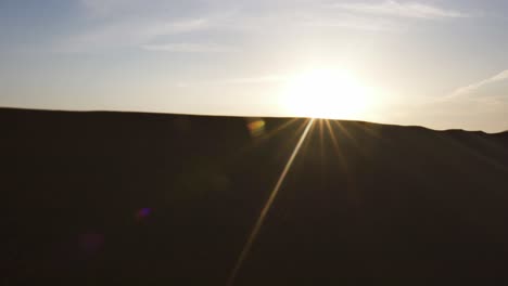 magical reveal shot of dreamy sunrise over abu dhabi barren sandy desert