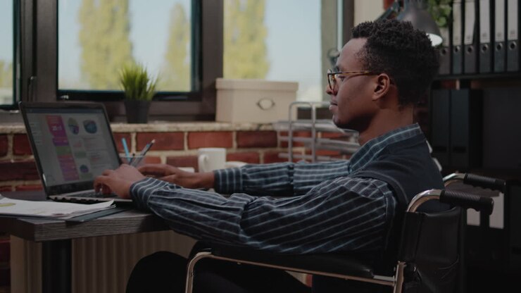 Business man sitting in wheelchair and working on startup company