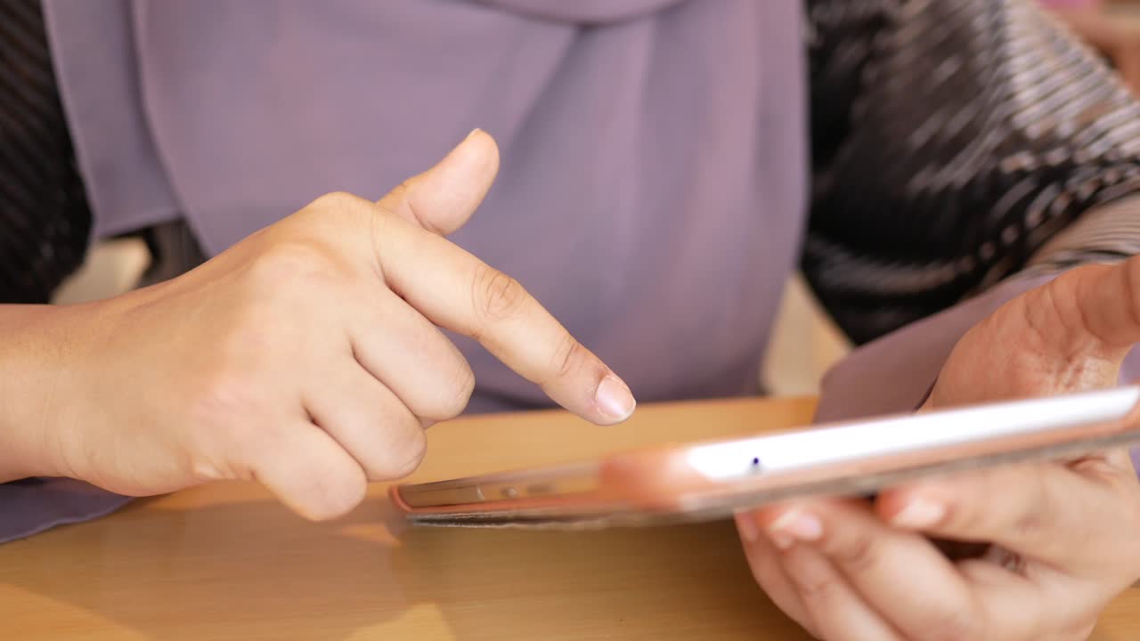 Woman using a mobile phone in a cafe