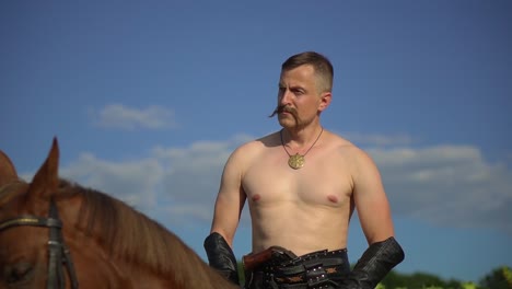 ukrainian cossack riding a horse in the field looks far 03