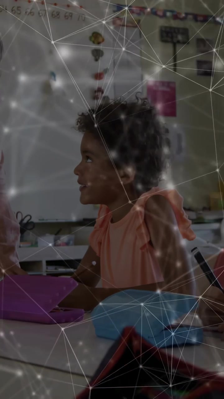 Vertical video: Kid reacting to school cue, moving from purple tablet to pencil, network overlay