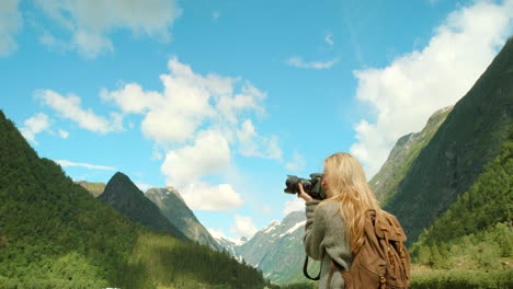 woman taking photo of norwegian fjords