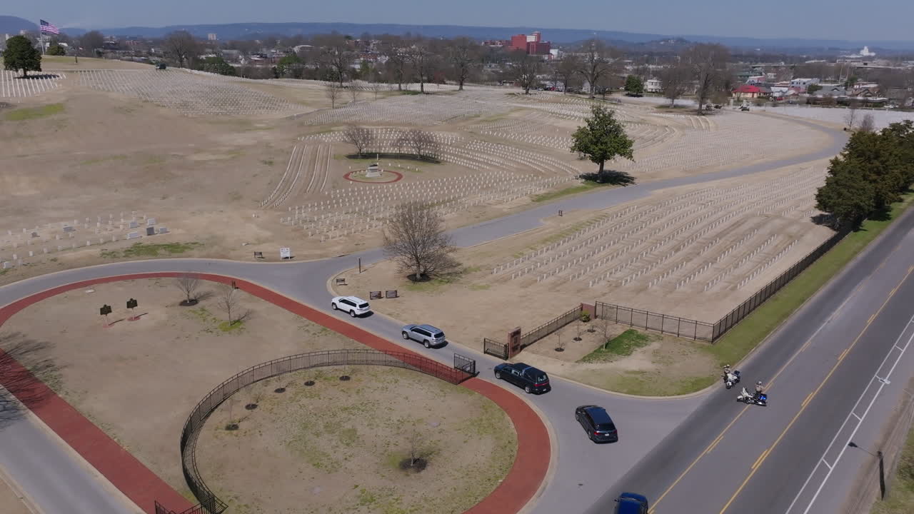 Aerial footage following a funeral procession as it enters Chattanooga National Cemetery.