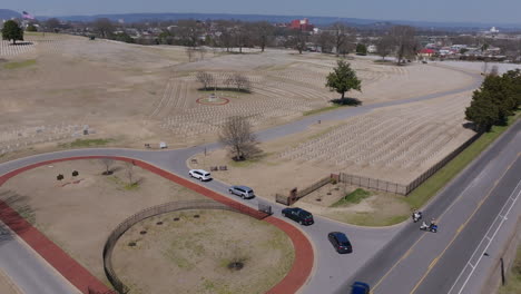 aerial footage following a funeral procession as it enters chattanooga national cemetery.