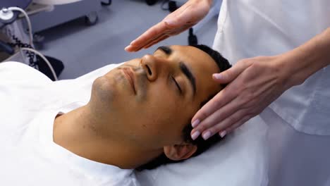 Male-patient-receiving-massage-from-doctor