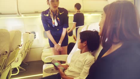 cabin crew provide service to family in airplane