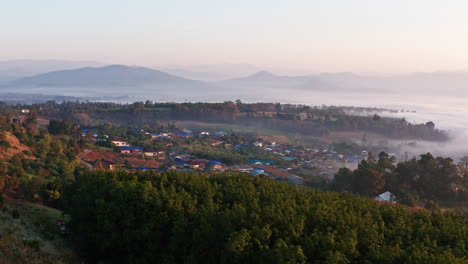 stunning aerial shot flying above the clouds at sunrise in pai, thailand