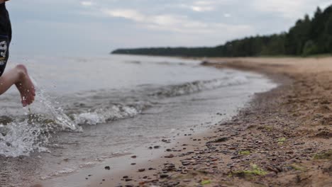 the child runs along the sea shore, does not see the face