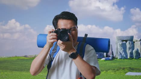 man taking photo of stonehenge
