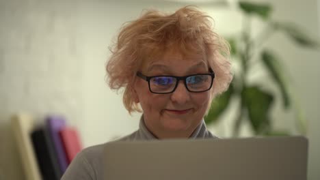 Head shot mature woman looking at camera and talking, grandmother chatting with relative online, making video call, middle aged blogger recording vlog, teacher speaking to webcam, distance lecture