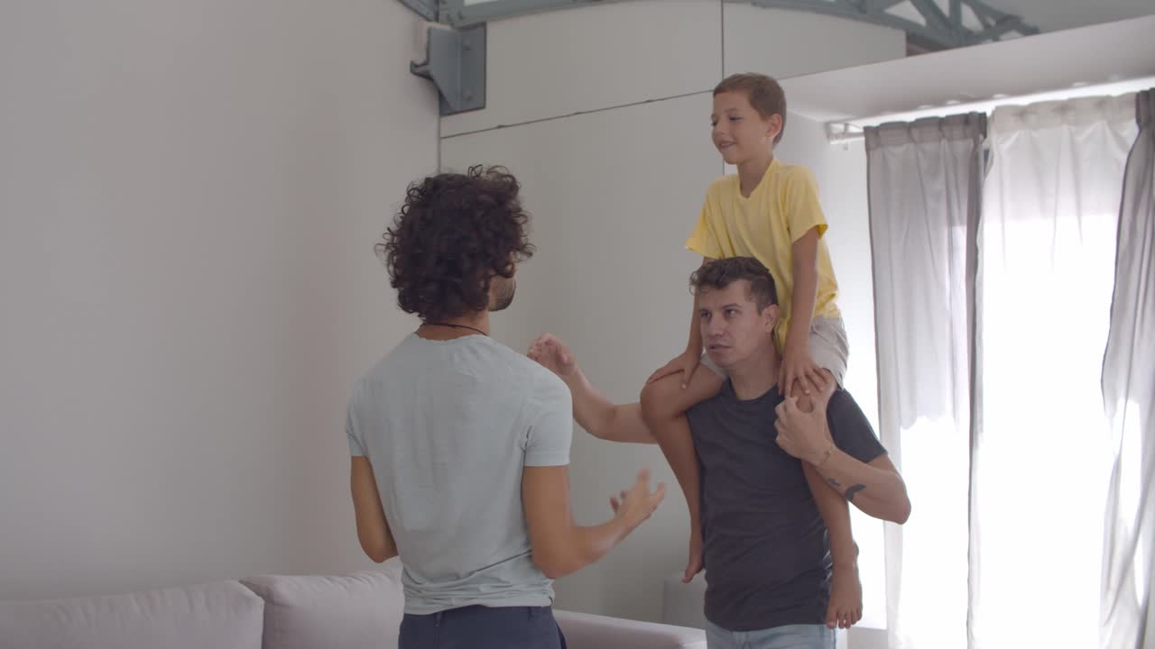 Happy kid riding on dads necks
