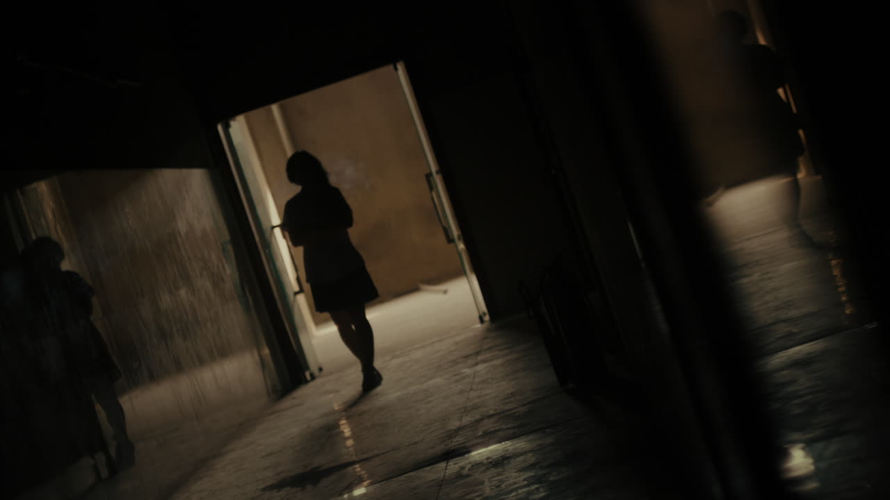 어두운 대학 고등학교 복도에서 혼자 고 있는 어린 소녀의 느린 움직임