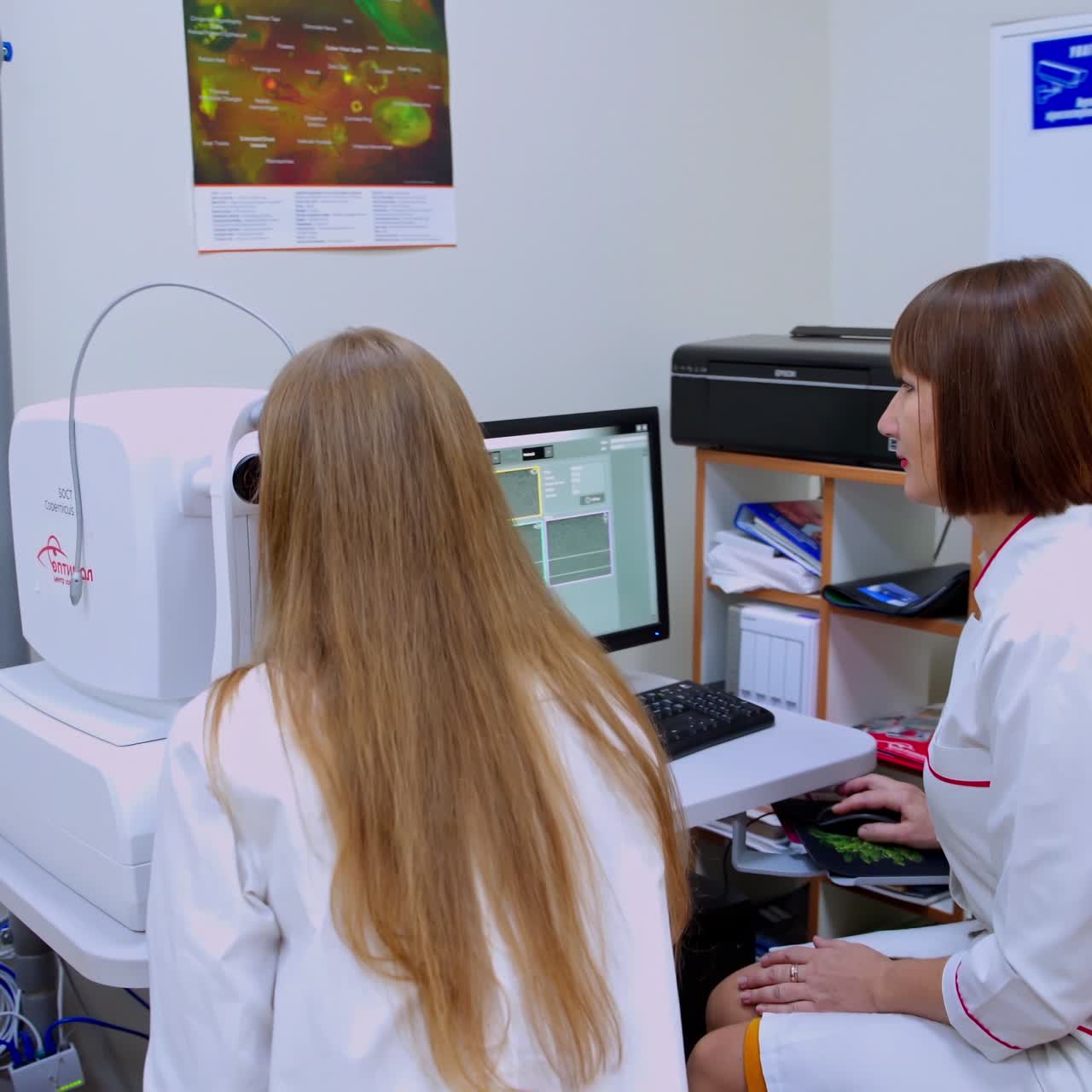 Eye clinic interior. Ophthalmologist examining woman's eyes in medical center. Specialist is testing patient's eyes on a refractometer machine.